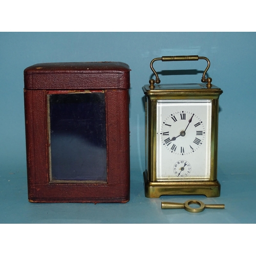 117 - An early-20th century French brass carriage clock, the white enamel face having Roman numerals above... 