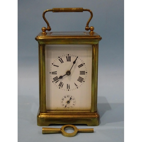 117 - An early-20th century French brass carriage clock, the white enamel face having Roman numerals above... 