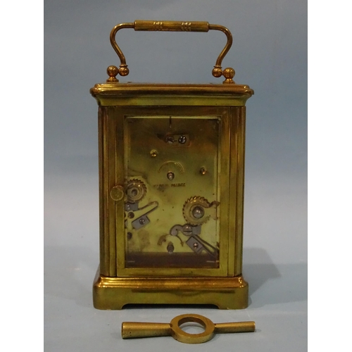 117 - An early-20th century French brass carriage clock, the white enamel face having Roman numerals above... 