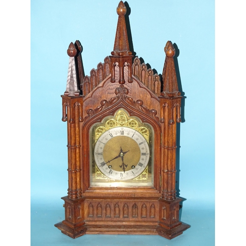 119 - A late-19th/early-20th century oak bracket clock, the architectural Gothic case enclosing a gong-str... 