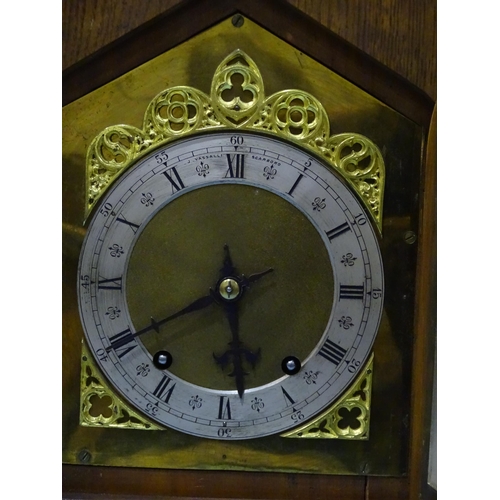 119 - A late-19th/early-20th century oak bracket clock, the architectural Gothic case enclosing a gong-str... 