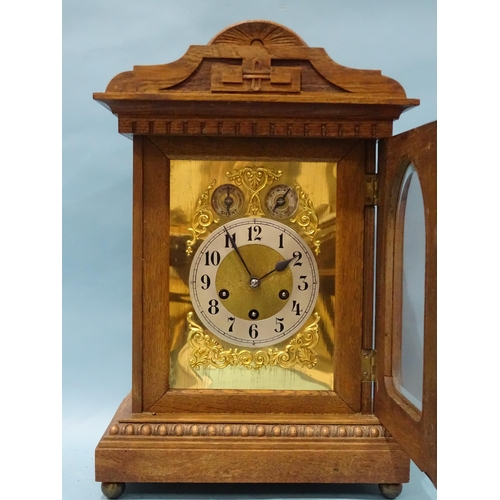 122 - An Edwardian oak-cased mantel or bracket clock, the movement striking on four chimes and a gong, the... 