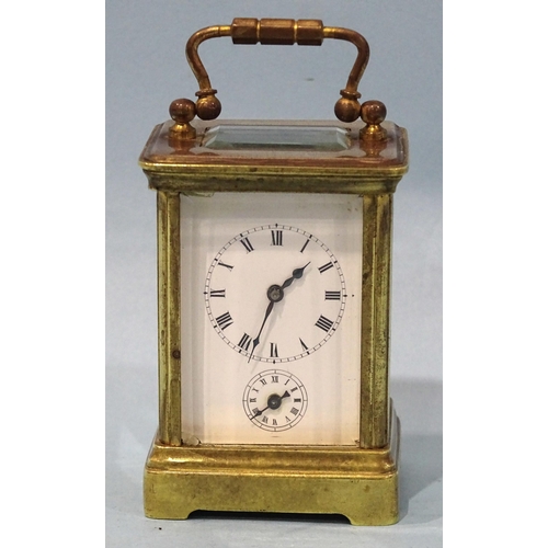 126 - A late-19th/early-20th century brass miniature carriage alarm clock, the white enamel face with dial... 