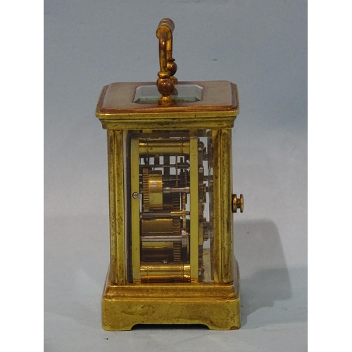 126 - A late-19th/early-20th century brass miniature carriage alarm clock, the white enamel face with dial... 