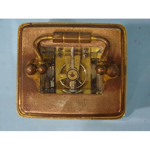 126 - A late-19th/early-20th century brass miniature carriage alarm clock, the white enamel face with dial... 