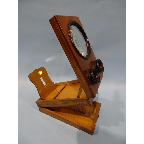 131 - A mahogany or walnut stereo-graphoscope with three lenses and folding viewing box.