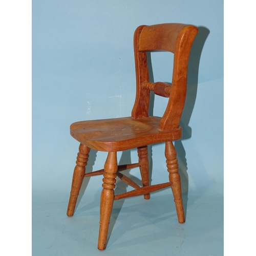 135 - A model of a rope-back kitchen chair, 30cm high, possibly an apprentice piece.