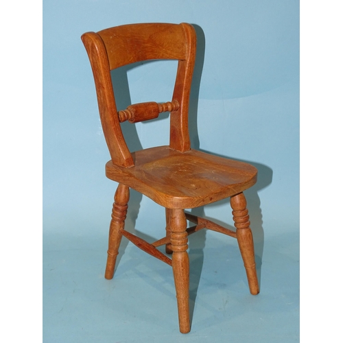 135 - A model of a rope-back kitchen chair, 30cm high, possibly an apprentice piece.