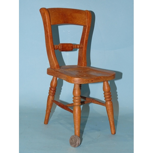 135 - A model of a rope-back kitchen chair, 30cm high, possibly an apprentice piece.