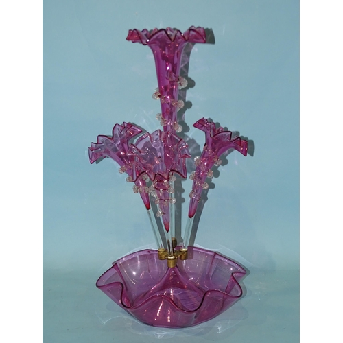 140 - A late-19th century cranberry glass epergne, the central trumpet vase flanked by three further vases... 