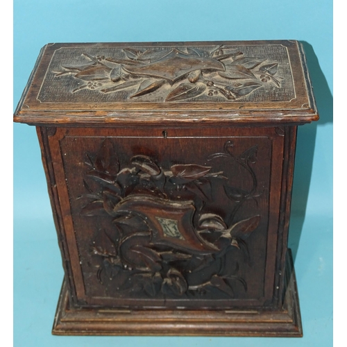 153 - A Continental carved stained wood collector's chest, with fall-front enclosing an interior fitted wi... 