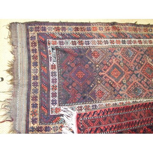 182 - An Oriental corridor carpet, the central field with diamond lozenges on a dark brown ground, within ... 