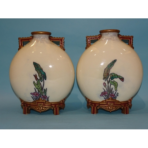 188 - A pair of 19th century Royal Worcester moon flasks, each having twin handles and raised on four feet... 