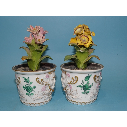 203 - A pair of Continental, 'red anchor' flowerpot ornaments, each floral spray within a planter decorate... 