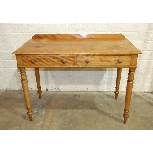 63 - A Victorian satinwood two-drawer side table, the rectangular top above two frieze drawers, on turned... 