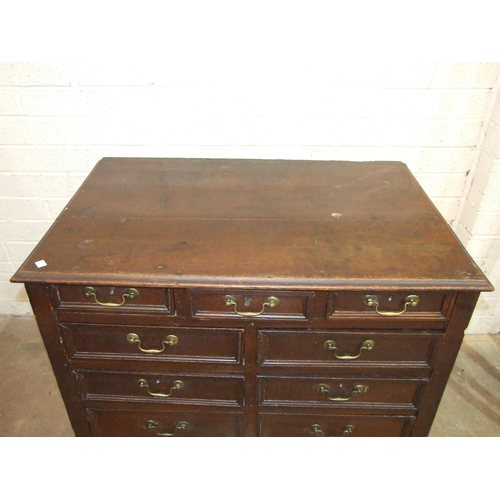 83 - An antique oak rectangular chest having an arrangement of eleven small drawers of varying size, 108c... 