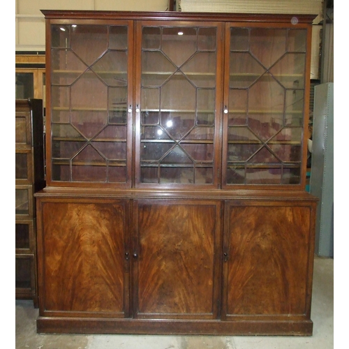 85 - A George III mahogany library bookcase, the moulded cornice above three astragal-glazed doors enclos... 