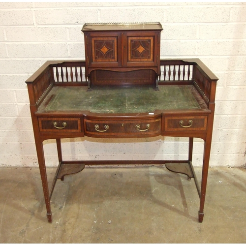 90 - An Edwardian mahogany crossbanded writing table, the galleried back with two small cupboard doors ab... 