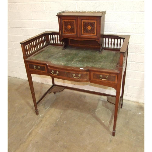 90 - An Edwardian mahogany crossbanded writing table, the galleried back with two small cupboard doors ab... 