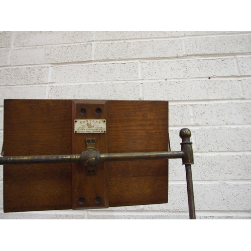 92 - A Victorian cast-iron adjustable music stand, the brass arm with oak stand labelled 