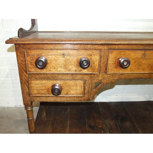 93 - An antique oak Welsh dresser, the plate rack with some original cup hooks, the base fitted with an a... 