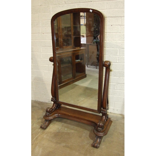 95 - A Victorian mahogany cheval mirror, the arch plate within scroll supports, (sconces lacking), 160cm ... 