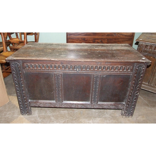 100 - An antique carved oak panelled coffer, 123cm long, 54cm deep, 65cm high.