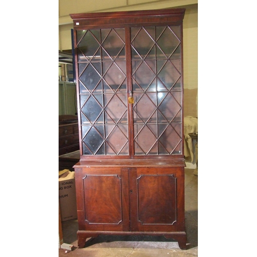 101 - A George III mahogany bookcase, the moulded cornice above a pair of astragal-glazed doors, the lower... 