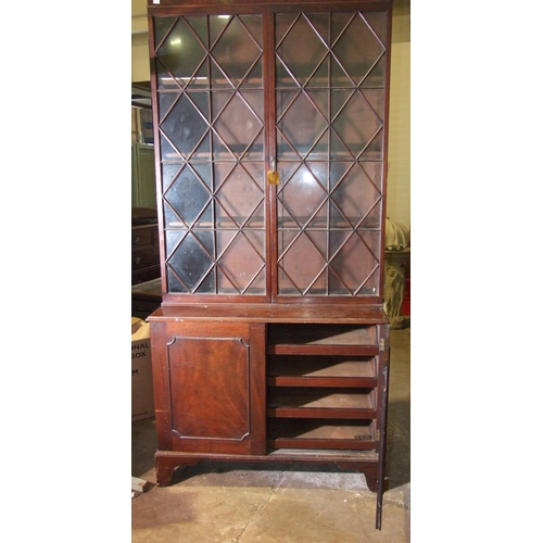 101 - A George III mahogany bookcase, the moulded cornice above a pair of astragal-glazed doors, the lower... 