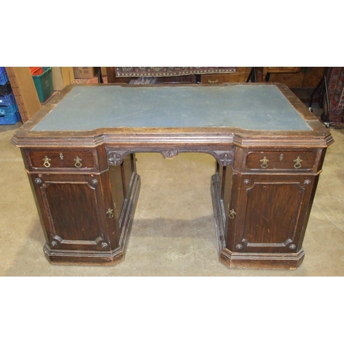 84 - A late-19th/early-20th century oak partner's desk, the top of broken outline having two small drawer... 