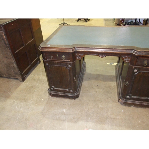 84 - A late-19th/early-20th century oak partner's desk, the top of broken outline having two small drawer... 