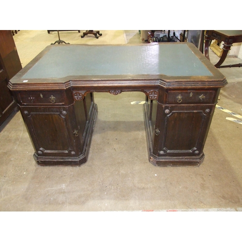 84 - A late-19th/early-20th century oak partner's desk, the top of broken outline having two small drawer... 