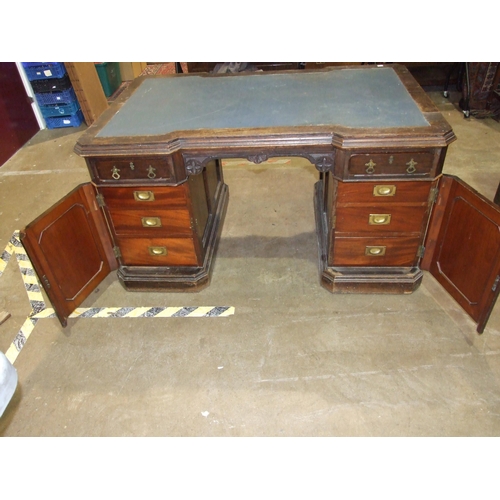 84 - A late-19th/early-20th century oak partner's desk, the top of broken outline having two small drawer... 