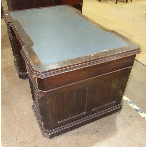 84 - A late-19th/early-20th century oak partner's desk, the top of broken outline having two small drawer... 