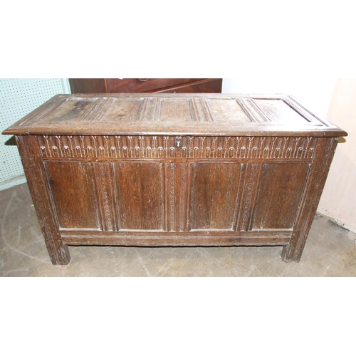 99 - An antique oak coffer with panelled top and sides, and carved frieze, 130cm wide, 56cm deep, 71cm hi... 