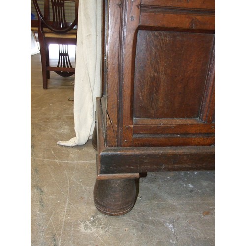 109 - A large antique oak two-door food cupboard, with later cornice above a pair of carved panelled doors... 