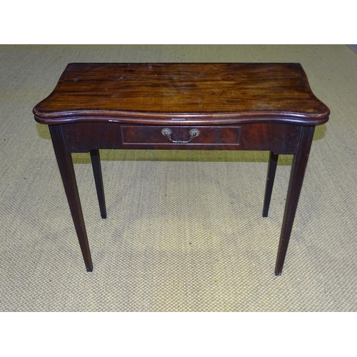 89 - A George III mahogany serpentine-shaped fold-over card table with frieze drawer, on square moulded l... 