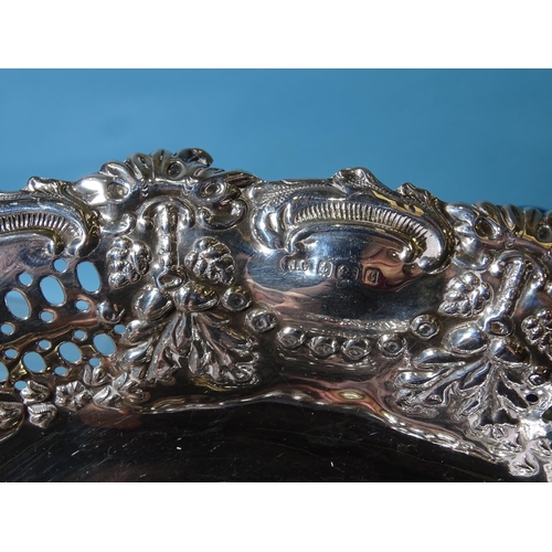 471 - An Edwardian silver oval stand with embossed and pierced decoration, 24.5 x 18.5cm, Birmingham 1902,... 