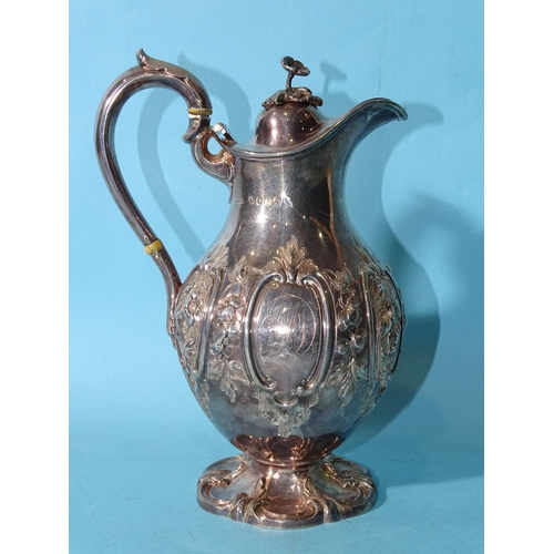 483 - A Victorian silver pear-shaped chocolate pot, the hinged cover with floral finial, the body with emb... 