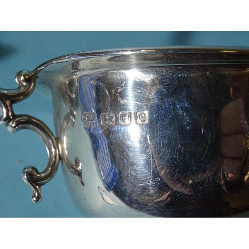 492 - A pair of silver sauce boats, each with leaf-capped C-scroll handle, Harrods Ltd, London 1938 and an... 