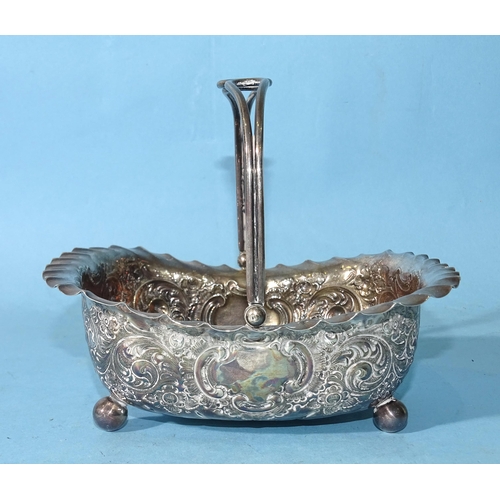 502 - A silver basket with embossed decoration and swing handle, on four ball feet, 14.5 x 11.5cm, 12.5cm ... 