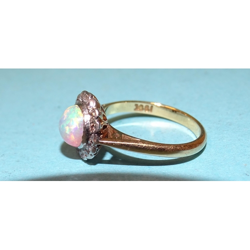 55 - An opal and diamond cluster ring set a round opal within a border of sixteen 8/8-cut diamonds, in 18... 