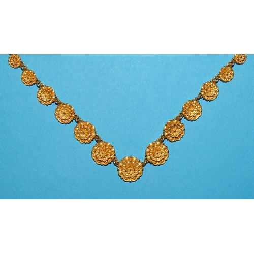 97 - A foreign gold necklace of graduated rosettes and a pair of matching earrings, all marked 18k, 33.3g... 