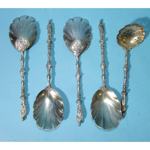 514 - A set of four Victorian dessert serving spoons and a sifter spoon, all with gilt shell bowl, chased ... 