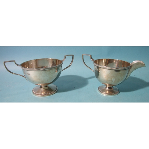 516 - A plain footed sugar basin and cream jug by Walker & Hall, Sheffield 1931, ___8.5oz.... 