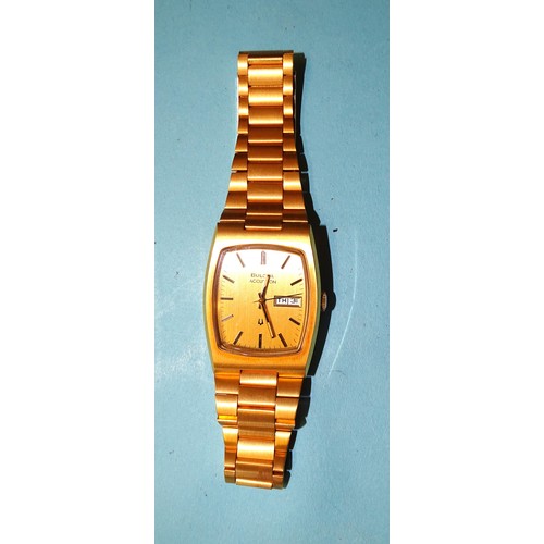 329 - A 1970's Bulova Accutron 2313 wrist watch, the gilt dial with day/date aperture and baton numerals, ... 