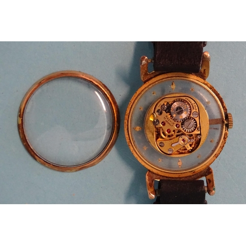 252 - Marvin, an unusual gold-plated wrist watch, the face with engraved centre disc within glass chapter ... 