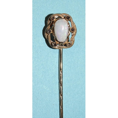 181 - An unmarked gold stickpin claw-set oval opal, within textured surround collet-set six rose-cut diamo... 