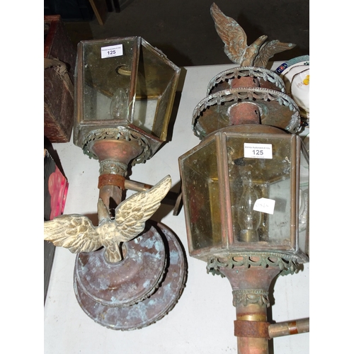 125 - A pair of brass external lanterns, each surmounted by an eagle, (in need of restoration), (2).... 