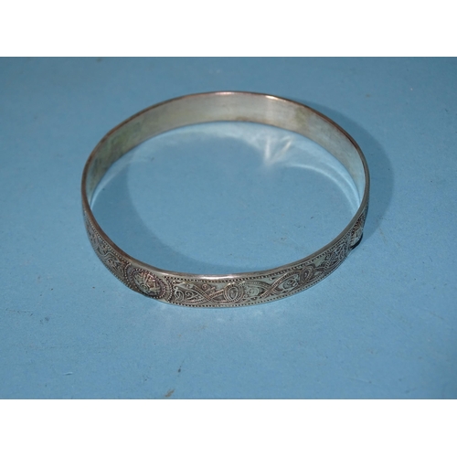 220 - Seven silver bangles of Celtic design by Gordon H Walker, three similar rings and one other, 183g, (... 